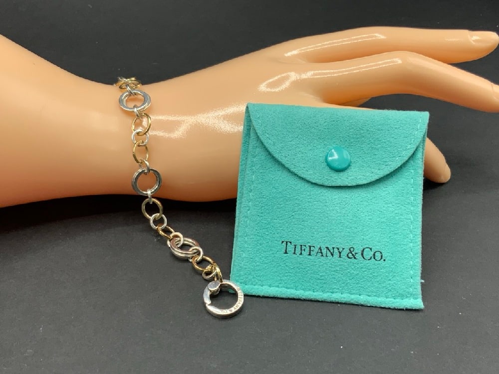 Tiffany and Company Sterling Silver and 18K Gold Interlocking Hoop Bracelet: Tiffany & Co. Sterling Silver and 8K Gold Interlocking Circle Hoops Bracelet. Original owner purchased over 40 years ago. Very fine condition. Sterling silver and solid 18K gold hoops varying in size.