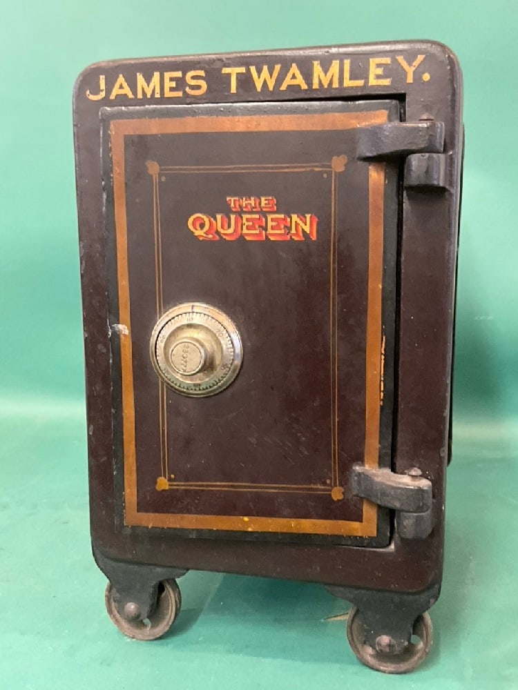 Small Antique Safe on Wheels “The Queen: Small Antique Safe on Wheels “The Queen”. Combination is present. Condition: worn - original paint, pinstripe, interior intact. Dimensions: 17” x 10 1/2” x 13”
