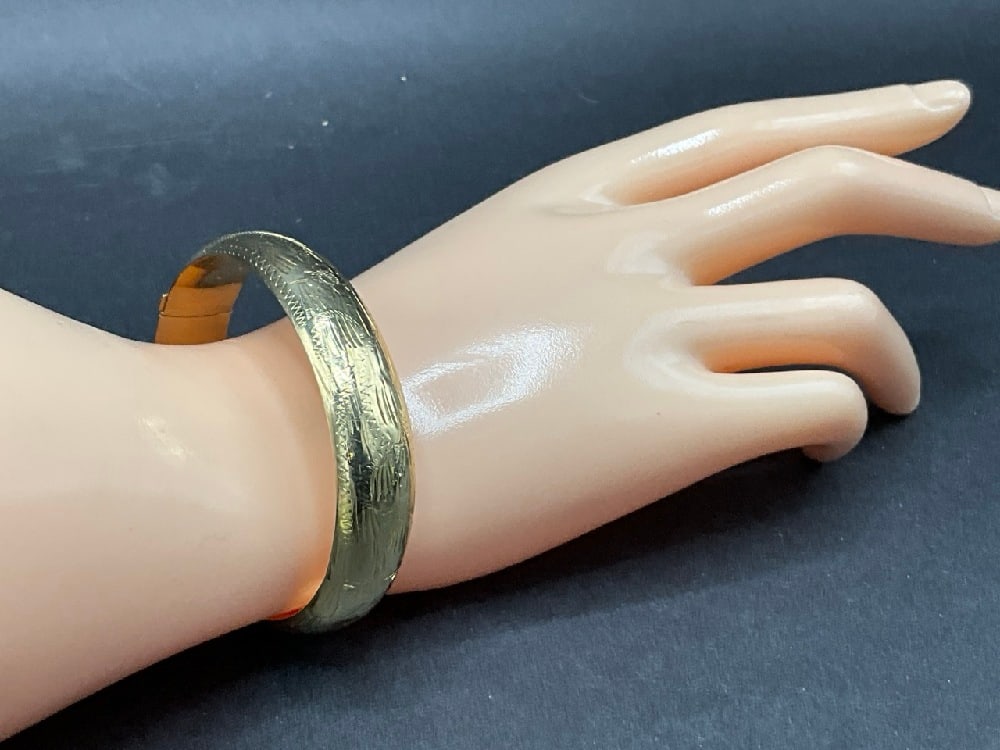 14K Yellow Gold Engraved Hinged Bracelet: 14K Yellow Gold Engraved Hinged Bracelet.Total weight: 18.7 grams, Dimensions: 2 3/8” I’d 1/2” width .Originally for Mother and Daughter (See lot 182).