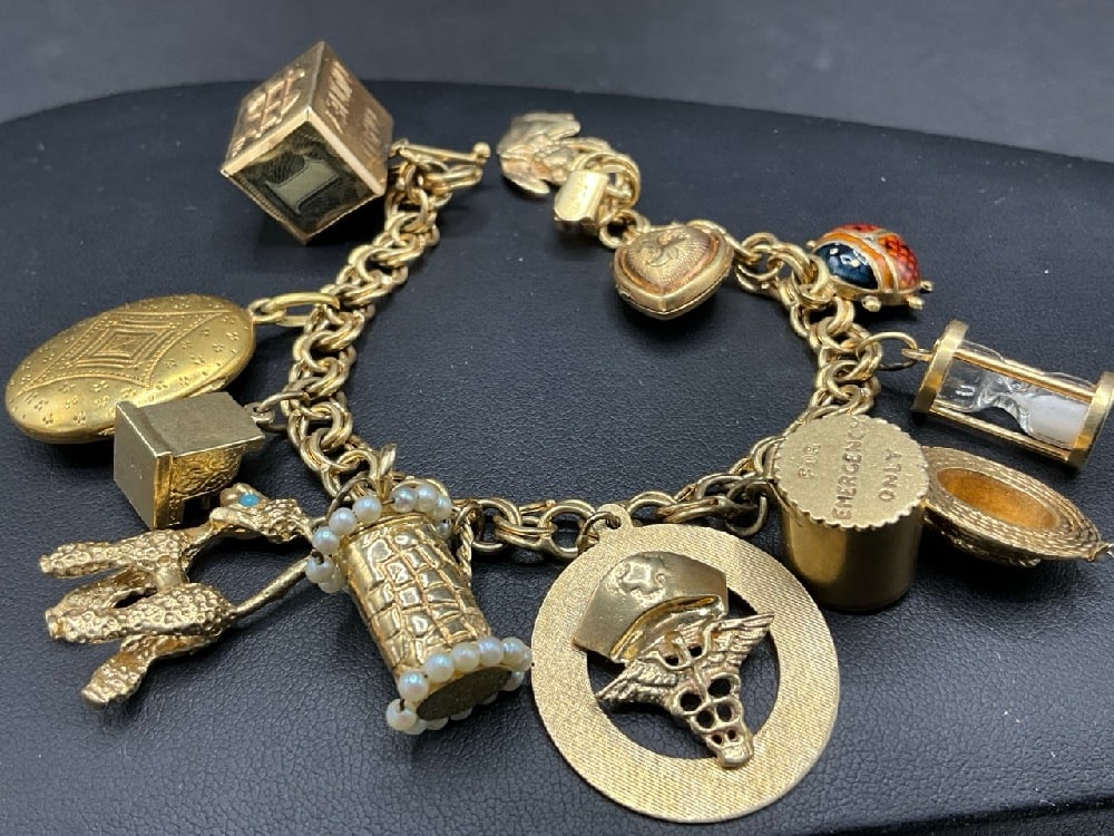 14K Yellow Gold 7" Charm Bracelet with 12 Charms: 14K Yellow Gold 7" Charm Bracelet with 12 Charms. All marked 14K. Total weight: 52.3 grams