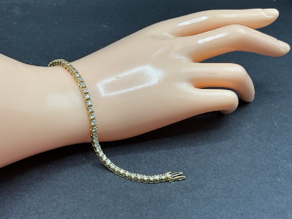 14K Yellow Gold Diamond Tennis Bracelet: 14K Yellow Gold Diamond Tennis Bracelet. Dimensions: 7 1/8” 1/8” wideTotal weight: 9.8 grams.