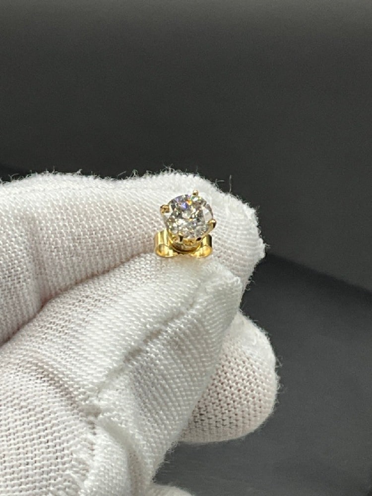 Single Diamond Stud Earring: Single diamond stud earring with 14K yellow gold post. .64-.68 5mm X 4mm size.