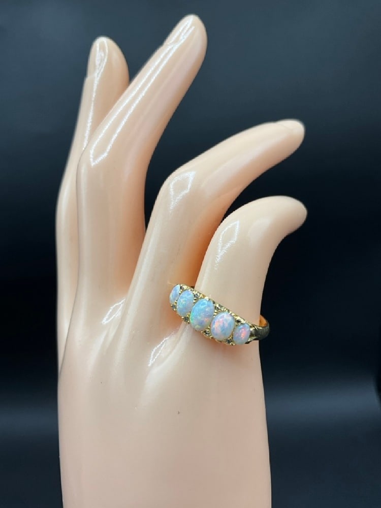 18K Yellow Gold European Opal Gemstone Ring: 18K Yellow Gold European Opal Gemstone Ring. This ring consists of five (5) natural oval cut white opals and eighteen (18) rose cut diamonds all prong set into an 18K Yellow gold mounting. The opals a