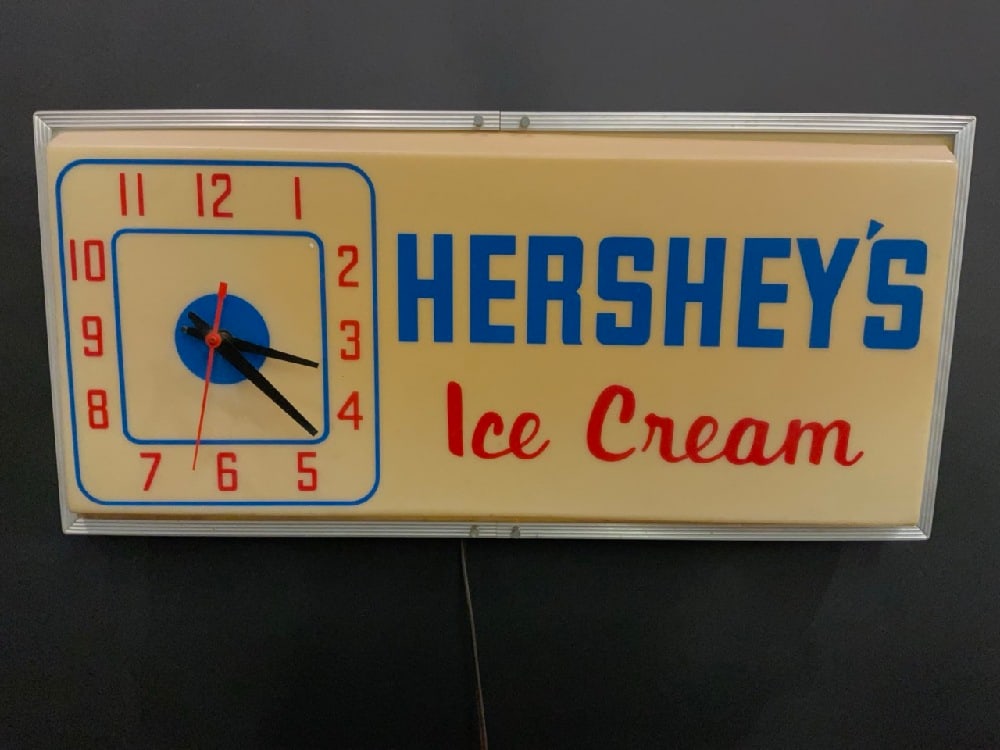 Vintage Light Up Hershey’s Ice Cream Clock: Vintage Light Up Hershey’s Ice Cream Clock.Condition: Light Flickering. Small crack in plastic on bottom. Dimensions: 12 1/2” x 26” x 5”