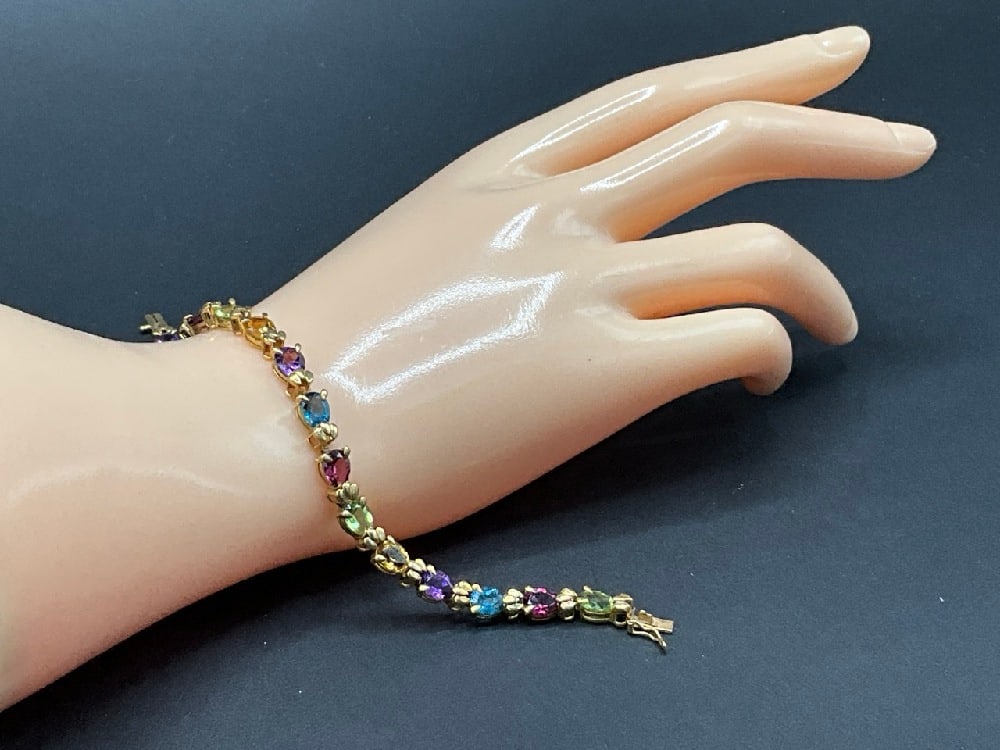 14K Yellow Gold Multi-Gemstone Bracelet: 14K Yellow Gold Multi-Gemstone Bracelet.Dimensions: 7 1/2” Total weight: 10.5 grams. Including Topaz, Amethyst, Citrine, Peridot and Garnet Gemstones.