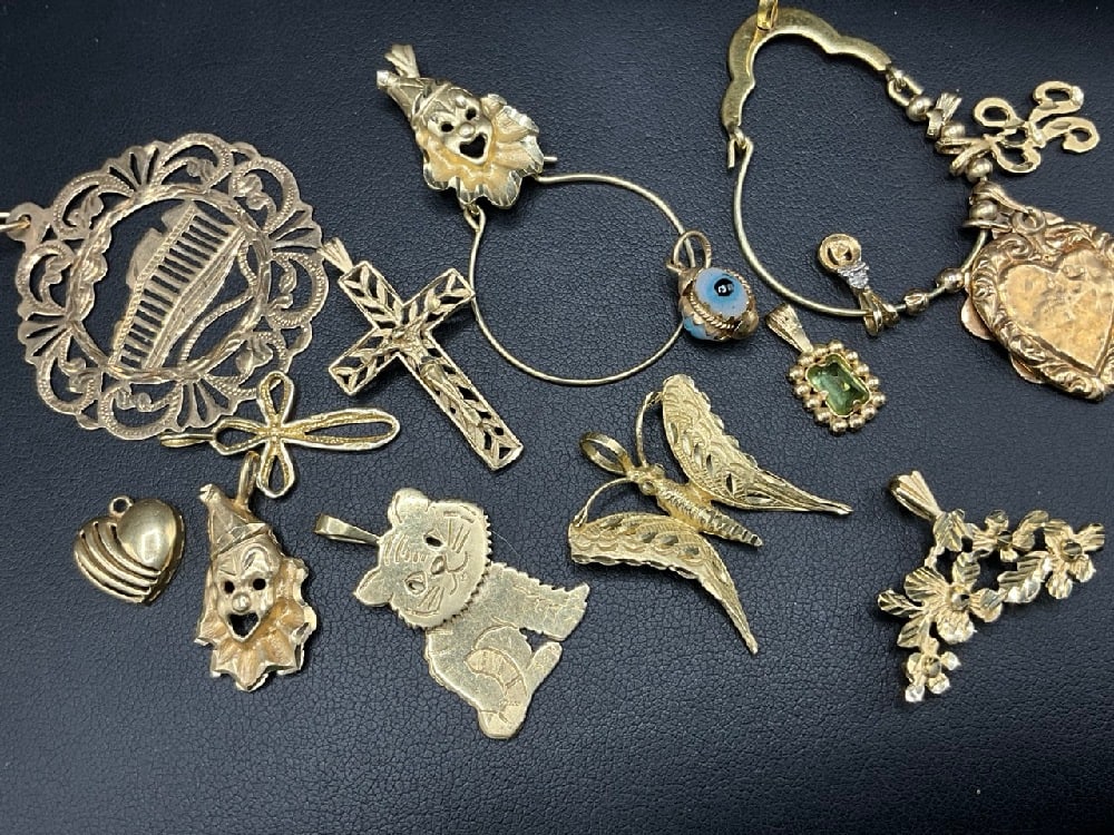 Large Group of 14K Yellow Gold Charms and Pendants: Large grouping of all 14K yellow gold charms and pendants. Includes two charm holders. Total weight: 26 grams.