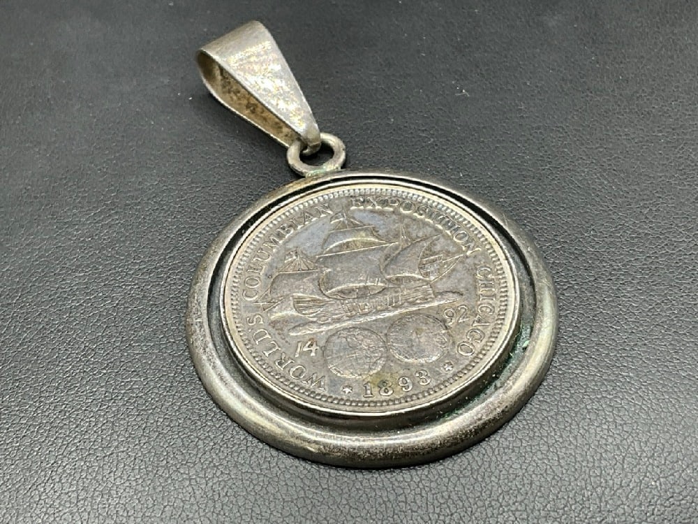 Charles Albert Sterling Silver Bezel Pendant with 1893 Columbian Expo Silver Half Dollar: Charles Albert Sterling Silver Bezel Pendant with 1893 Columbian Expo Silver Half Dollar. 90% Silver purity. Total weight: 23.1 g Dimensions: 2 1/2” x 1 1/2”