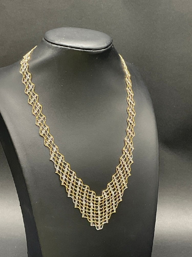 14K Yellow and White Gold Elegant Bib Style Necklace: 14K Yellow and White Gold Elegant Bib Style Necklace.Dimensions: 17” Graduates from 1/4” - 1 1/4” Total weight: 13.3 grams.