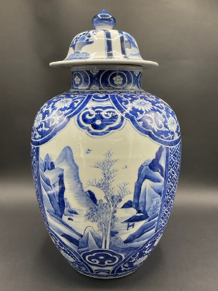 Antique Chinese Blue and White Porcelain Lidded Jar w/ Leaf Mark: Antique Chinese Blue and White Porcelain Lidded Jar. Depicting a canyon landscape with running river between and verso basket of flowers. Signed at base with drawn leaf. Dimensions: 19” H x
