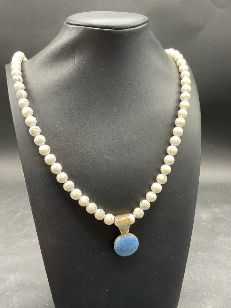 White Turquoise Bead Necklace with Christopher Wolf Sterling Silver Pendant: White Turquoise Bead Necklace with Christopher Wolf Sterling Silver Pendant. Dimensions: 1 1/4” and 24" length.