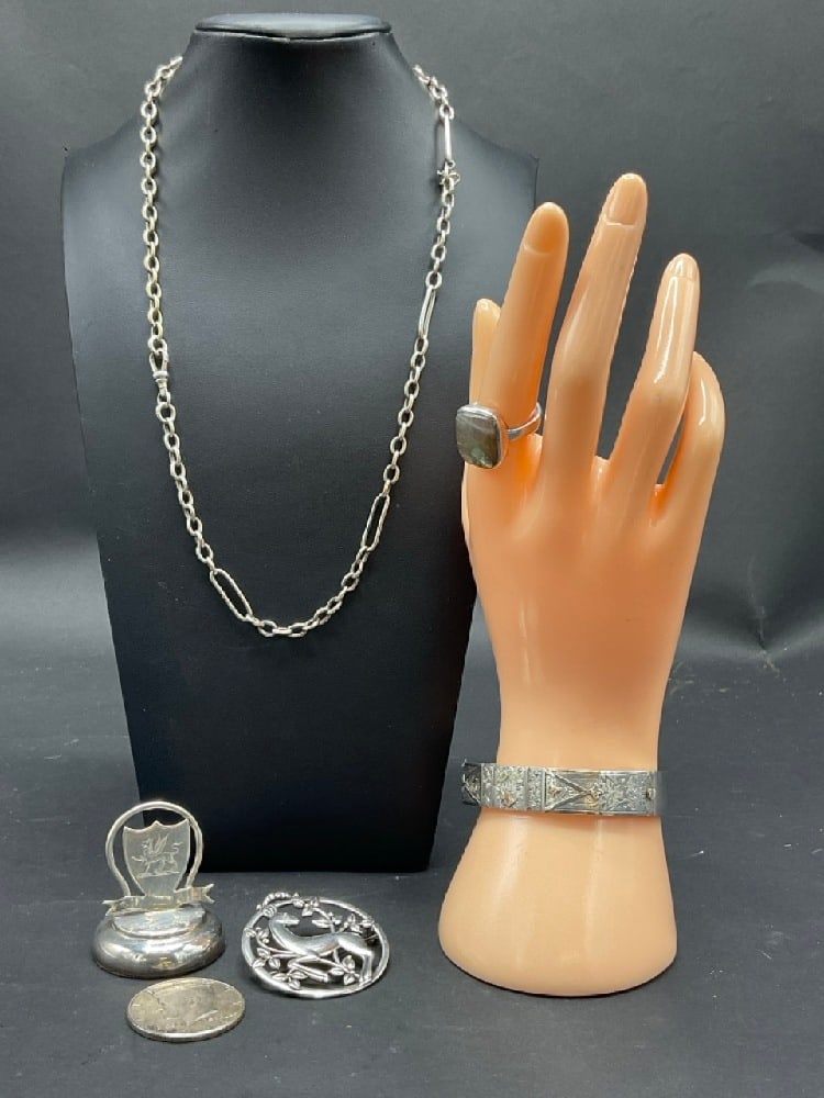Compiled Sterling Silver Jewelry Group. 1964 Kennedy Half, Labradorite ring (side chip to stone: Compiled Sterling Silver Jewelry Group. 1964 Kennedy Half, Labradorite ring (side chip to stone noted) Necklace, Bracelet, Pin and weight. As seen in photograph preview. Total weight: 155 grams.