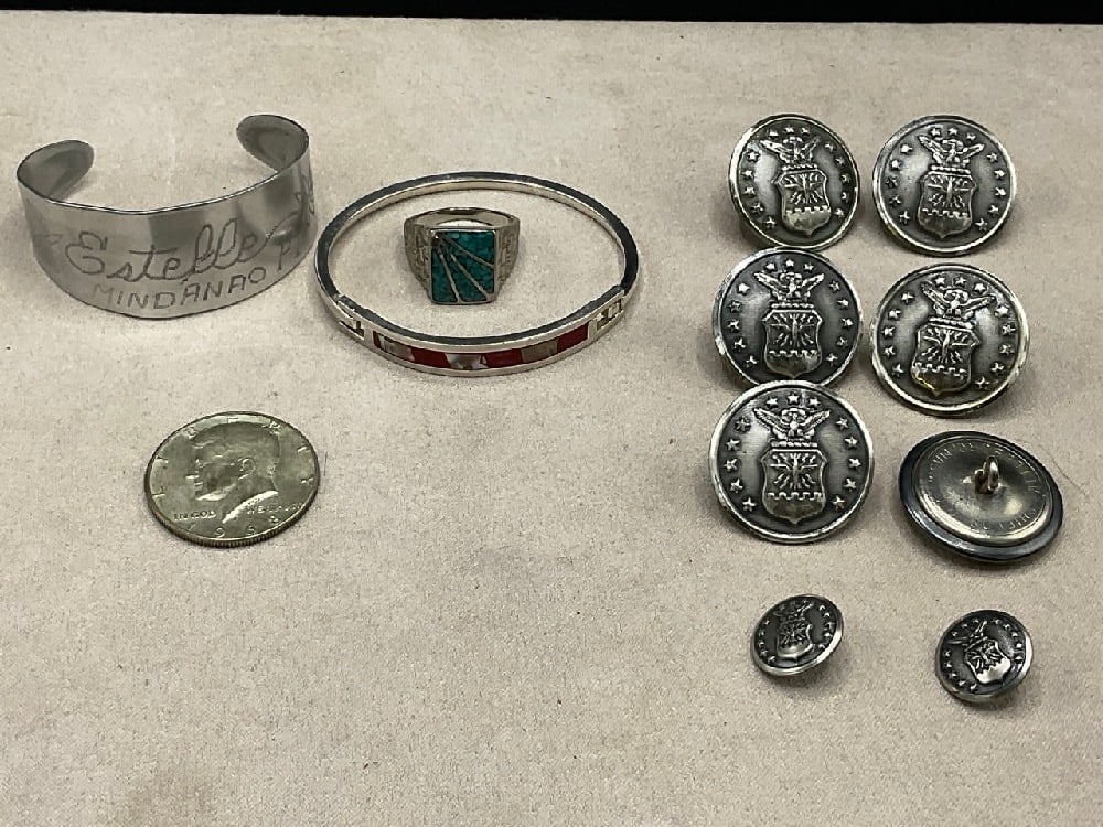 Trench Art Cuff, (8) Air Force Buttons, Silver Half Dollar, Turquoise Ring and Sterling Hinged: Trench Art Cuff, (8) Air Force Buttons, Silver Half Dollar, Turquoise Ring and Sterling Hinged Bracelet. As seen in photograph preview.