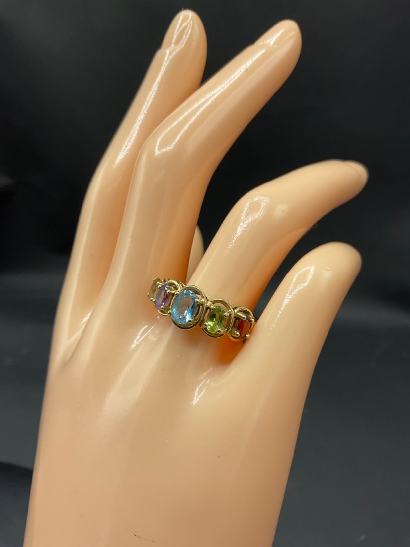 10K Yellow Gold Multi-Gemstone Mother's Ring: 10K Yellow Gold Multi-Gemstone Mother's Ring. Having citrine, topaz, amethyst and blue topaz stones. Size 8.Total weight: 3 grams.