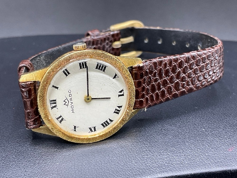 18K Yellow Gold Women’s Movado Wrist Watch: 18K Yellow Gold Women’s Movado Wrist Watch with Leather Band. 17J Unadjusted. Working order. Dimensions: 25.5 mm case with crown. Total weight: 16 grams.