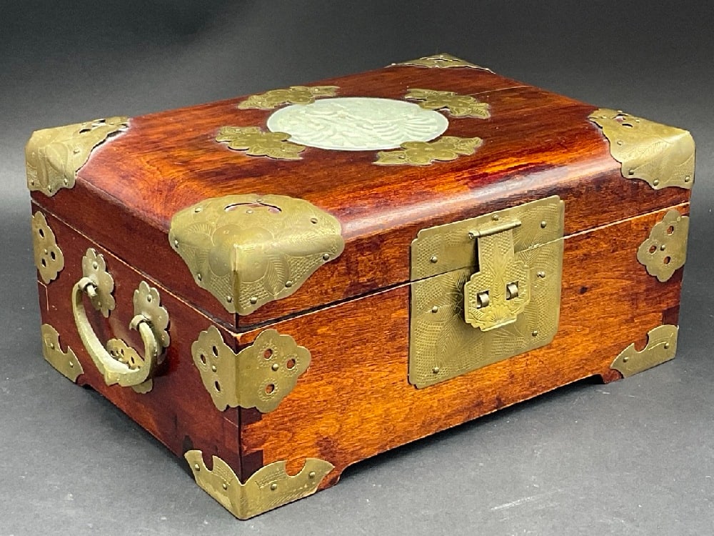 Chinese Jade and Wood Jewelry Box: Chinese Jade and Wood Jewelry Box. Red pillow lined interior. Metal tag affixed to backside "Shanghai, China".Condition: One side has stress crack. Please see photograph preview.Dimensions: 4 1/2&rdqu