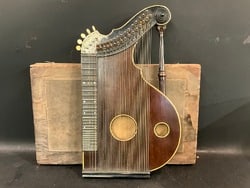 Antique 19th Century Musical Zither Instrument: Antique 19th Century Musical Zither Instrument. Architectural Column elements. One string missing. Overall good condition. Comes with original case. Unsigned. Dimensions: 23 3/4” x 14”