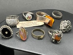 Nine (9) Compiled Sterling Silver Rings: Nine (9) Compiled Sterling Silver Rings Including Baltic Amber. Total Weight: 58 grams.