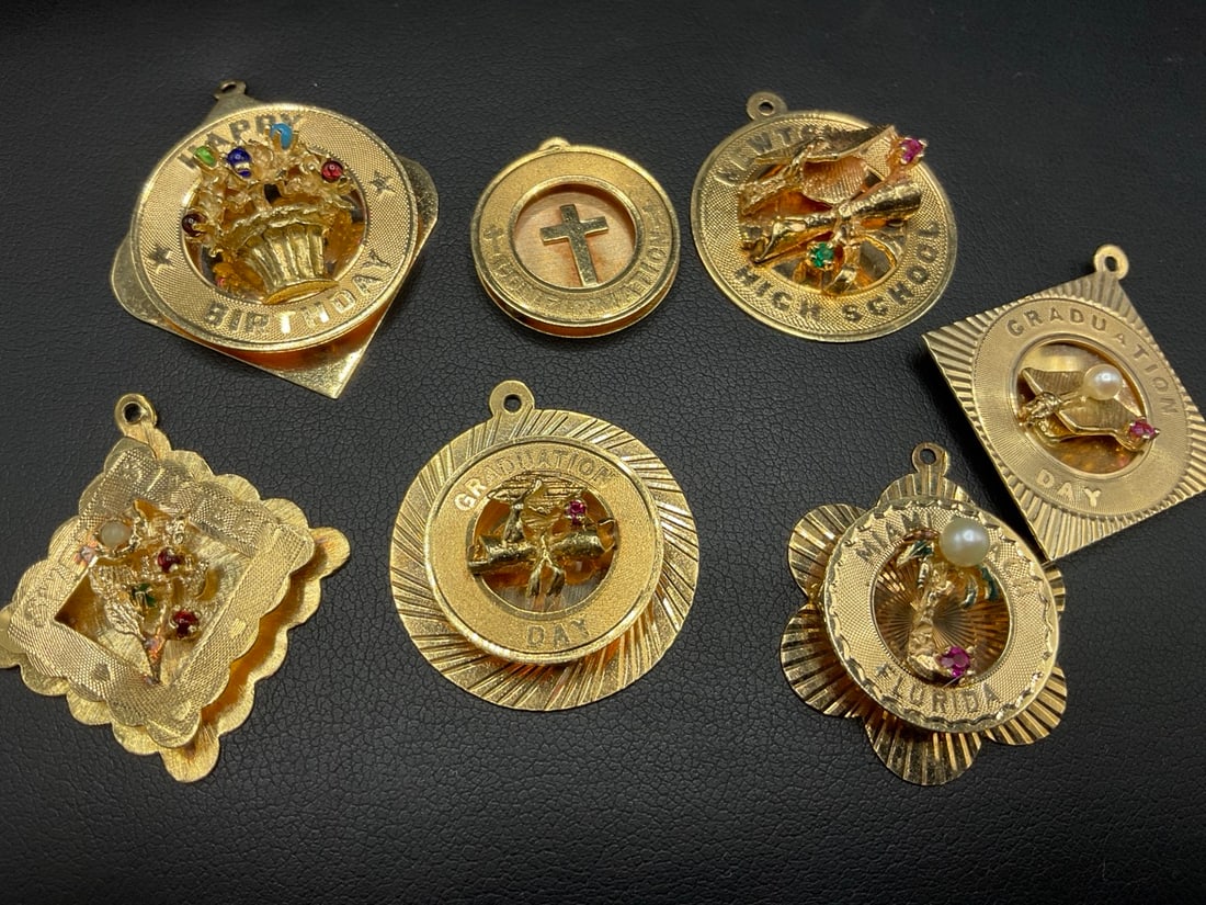 Seven (7) 14K Yellow Gold Charms: Seven (7) 14K Yellow Gold Charms. All vintage c. 1960's. Miami Beach, Sweet Sixteen, Newtown High School, First Communion etc. As seen in photograph preview. Total weight: 29.7 grams. Dimensions: 1