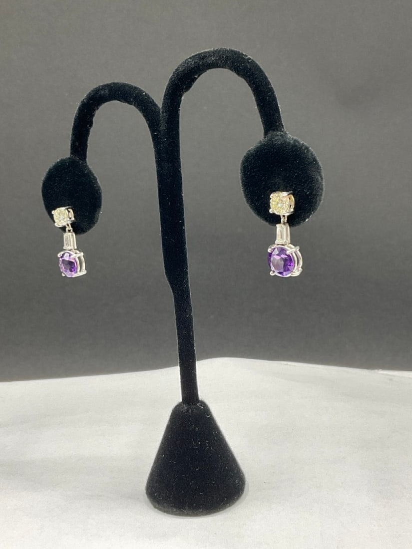 18K White Gold Diamond and Amethyst Dangle Stud Earrings: 18K White Gold Diamond and Amethyst Dangle Stud Earrings. Pierced. Missing original backs,Total weight: 5.5 grams.Dimensions: 7/8? drop.Two (2) .83 ct 5.4mm x 4.22mm round diamonds.Two (2) baquette di