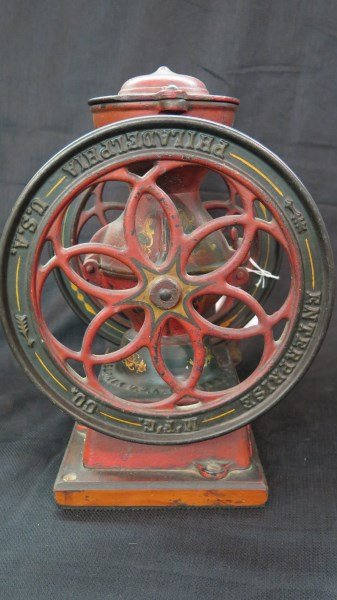 Enterprise Coffee Mill Philladelphia: An Enterprise Coffee Mill Philadelphia. 8.5" Diameter Wheel, 12" Height , 6" Depth. All Metal with drawer. Nice original decoration