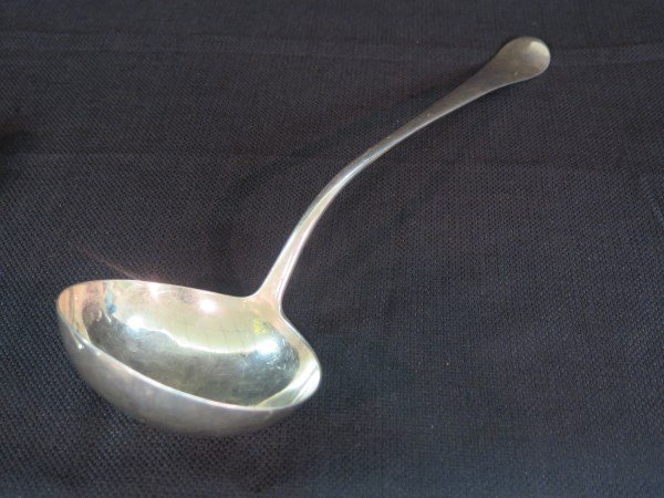 A Georgian sterling silver soup ladle c.1757: A Georgian sterling silver soup ladle, (marks partially rubbed) , Made in London c.1757Engraved Lion mono.Dimensions: 14" LengthTotal Weight: 188 gramsProvenance: James Robinson, New YorkProvenance: E