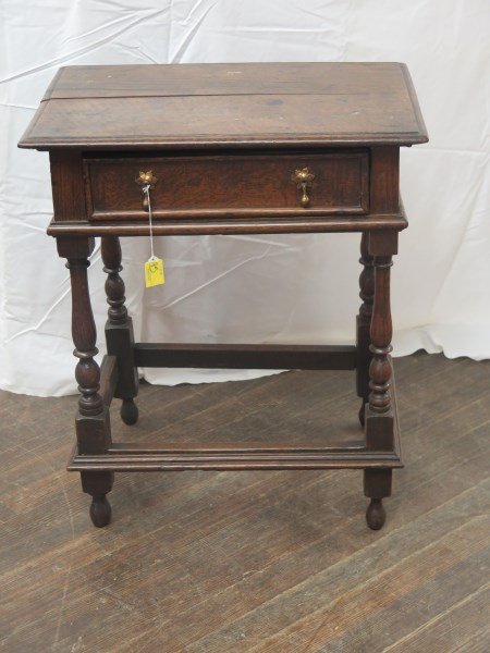 English William and Mary Carved Oak Side Table: An English William and Mary carved oak side table, late 17th century, the molded rectangular top above a frieze with One (1) drawer, raised on turned and blocked legs joined by stretchers.Dimensions:2