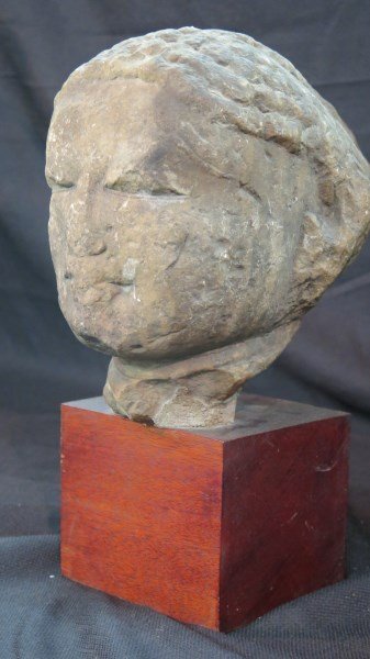 Early Architectural Carved Stone Buddha Statue: An Early carved stone Buddha head. Carved stone showing a significant amount of age and wear. Measures: 9" Height 8.5" Depth and 6" Width.