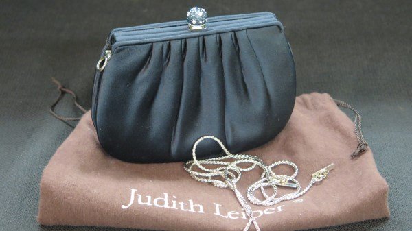 Judith Leiber Blue Sapphire Rhinestone Decorated Purse: A Judith Leiber signed evening purse in black with blue sapphire rhinestone ball clasp. Can be worn with silver chain or without as a clutch. Comes with dust bag. Dimensions: 6" X 5". Worn once. Inv.