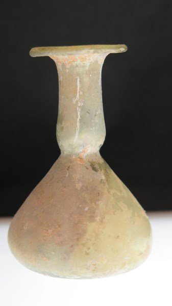 Ancient Roman Glass Bottle: An Ancient Roman Glass bottle. Dimensions 2 3/4" h X 2" w. Undamaged. Green iridescent coloring.