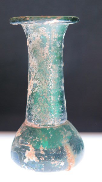 Ancient Roman Glass Bottle... Green: An Ancient Roman glass bottle, Jade green color. Dimensions: 3"h X 1 1/2" width.