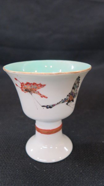 Antique Chinese Celadon Egg Cup: An Antique Chinese egg cup with butterfly decoration and Celadon interior. Signed at base. Dimensions: 3.5" X 3"d.Inv. 396