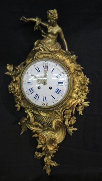 Fancy A.D. Moudin French Bronze Wall Clock: A Highly Ornate French Bronze Wall Clock signed on workings A.D. Moudin. Excellent Patina. Fine Bronze Casing. Enameled dial repaired at half hour "30". Please see photograph preview. Dimensions: 24"