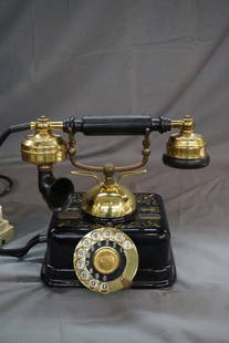 Danish Antique Enameled Telephone: A black enameled antique telephone. Fancy gold accents. Made in Denmark. Shop Guaranty label at base and impressed "KJOBENHAVNS TELEFON ALTIESELSKAB." Dimensions: 7.5" X 9" X 6"Inv. 8