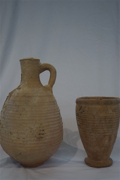 Roman Earthenware Cup & Jug: Roman Earthenware cup and jug. Dimensions: 8 1/2" X 5" and 5" X 3"Provenance: Collection of the late Mr. Hugh D. Farley.Mr. Farley acquired the pieces while he was the Director of the US Foreign Aid P