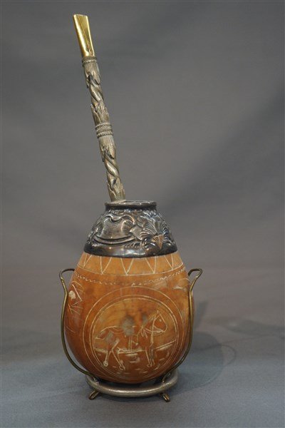 Argentinian Tea Gourd and Silver Bombilla: An Argentinian tea gourd with silver top and Bombilla being 800 silver. Dimensions: 4 1/2" X 3" Inv. 43