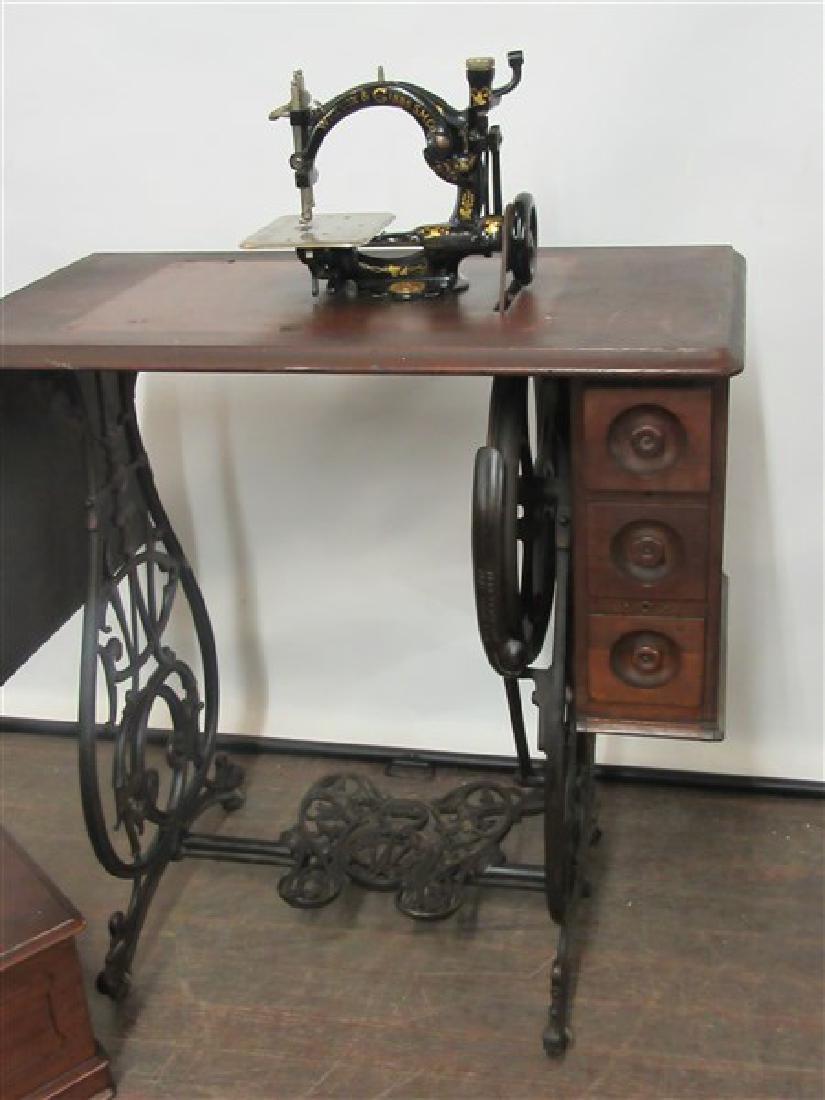 Wilcox & Gibbs Sewing Machine: A Wilcox & Gibbs antique sewing machine. Housed in original table. Dimensions: 38" X 28" X 16"