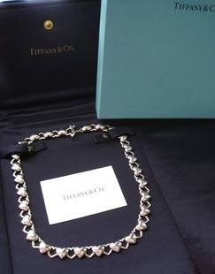 Tiffany & Co Heart & Arrow Necklace: Tiffany & Co Heart with Arrow Toggle Necklace. You can no longer purchase this at Tiffany & Co. The pictures do not capture the true beauty of this necklace. You will not be disappointed!The necklace