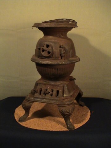 Child size cast iron pot belly stove, pot lifter i: Child size cast iron pot belly stove, pot lifter is not original but is included, item measures 14 inches tall and is heavy (expensive ship based on weight), has oxidation over all and needs refinishe