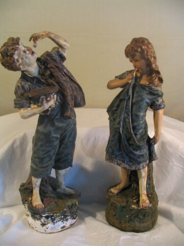 Pair of plaster figural statues, boy eating grape: Pair of plaster figural statues, boy eating grapes and shy girl, mold numbers on back 235 and 237, have missing paint and a few minor flakes, 20 inches tall, as found in estate, age/origin unknown