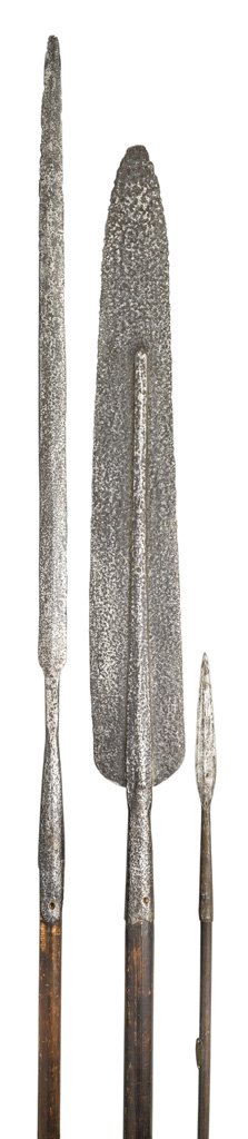 **THREE AFRICAN SPEARS, 19TH CENTURY the first probably: **THREE AFRICAN SPEARS, 19TH CENTURY the first probably South African, with broad leaf-shaped blade retained by a long tubular medial ridge, tapering socket and later wooden haft; the second with long