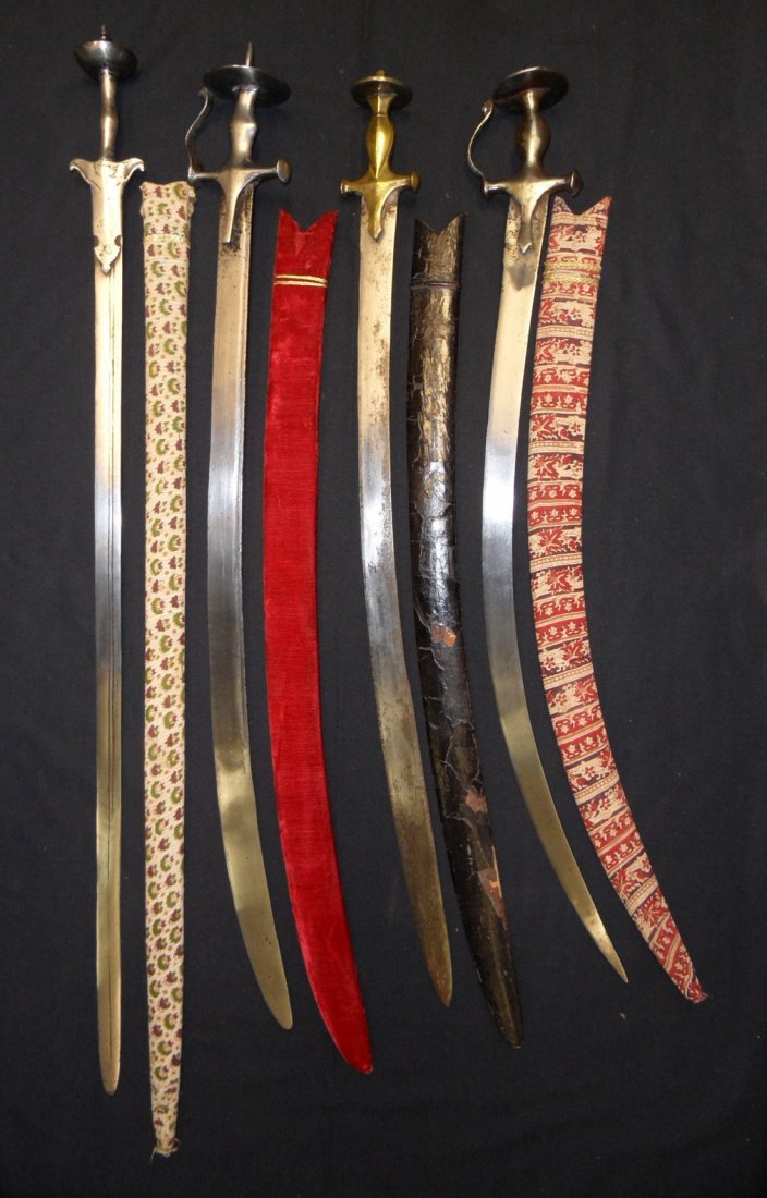 AN INDIAN SWORD (KHANDA) 17TH/18TH CENTURY AND THREE: AN INDIAN SWORD (KHANDA) 17TH/18TH CENTURY AND THREE FURTHER INDIAN SWORDS (TALWAR), 19TH CENTURY the first with tapering blade double-edged towards the point, iron hilt including a pair of shaped lan