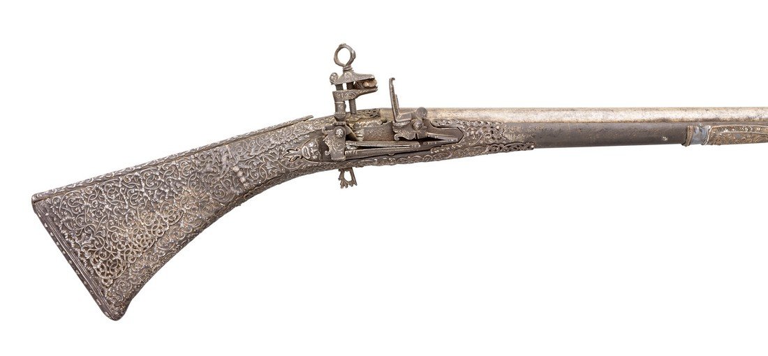 AN 11 BORE SARDINIAN MIQUELET-LOCK GUN, 18TH CENTURY: AN 11 BORE SARDINIAN MIQUELET-LOCK GUN, 18TH CENTURY cut-down to carbine length, with associated sighted barrel, chiselled lock decorated with scrollwork, wooden full stock almost entirely covered in 