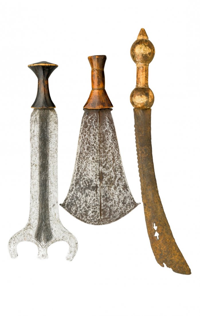 THREE CENTRAL AFRICAN SHORTSWORDS, 19TH/EARLY 20TH: THREE CENTRAL AFRICAN SHORTSWORDS, 19TH/EARLY 20TH CENTURY the first probably Congo, with E-shaped head and broad blade cut with numerous slender fullers on each face, the second a Monda knife, possib