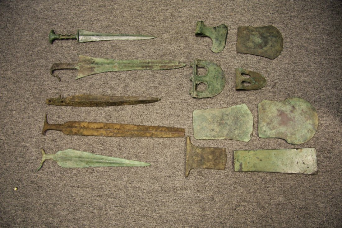 A BRONZE DAGGER, POSSIBLY LURISTAN 12TH TO 9TH CENTURY: A BRONZE DAGGER, POSSIBLY LURISTAN 12TH TO 9TH CENTURY B.C. AND TWELVE FURTHER BRONZE WEAPONS the first in excavated condition, with double-edged blade, integral hilt including elliptical pommel and h