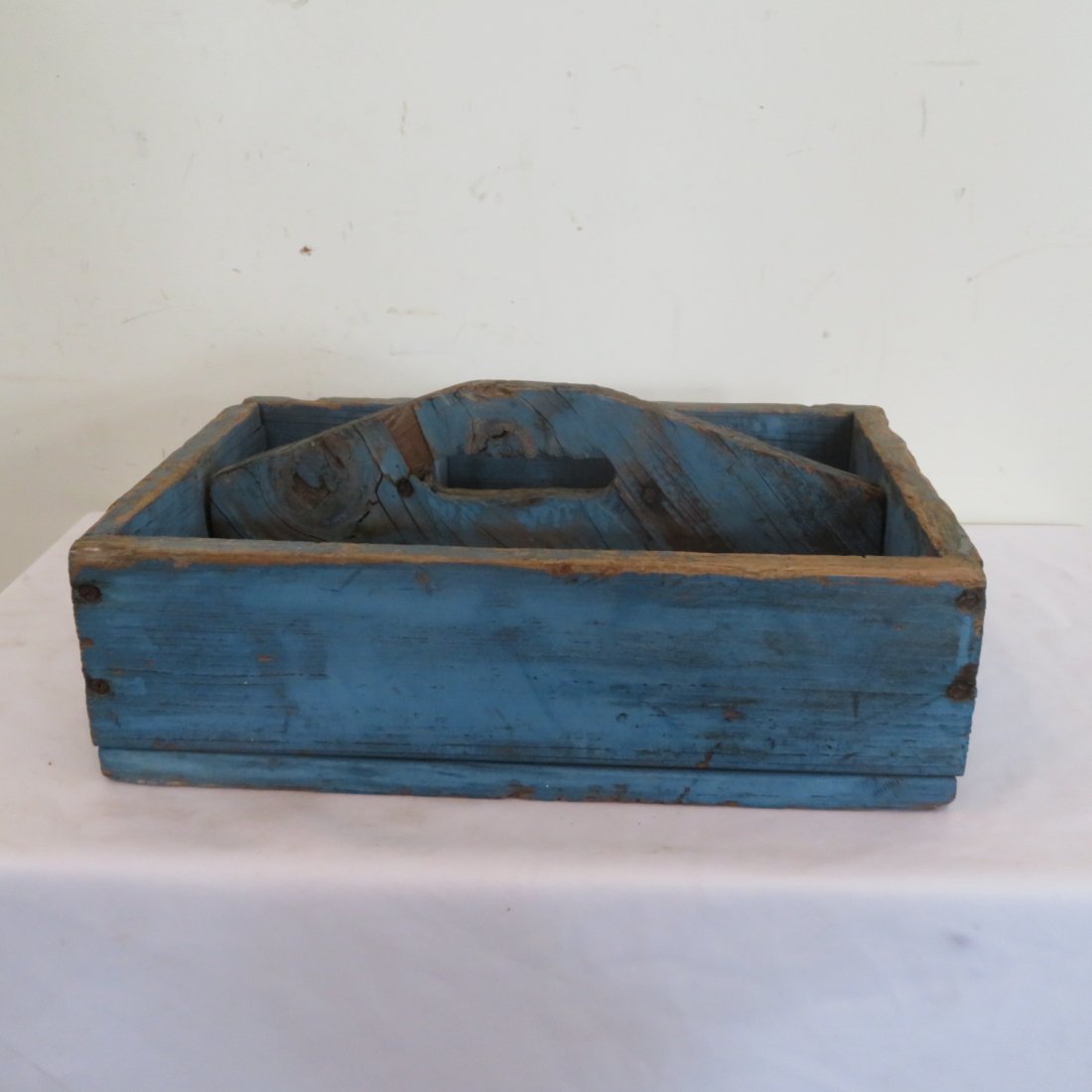 Home made tool carrier in old blue paint: Ca. 1940's home made tool carrier in old blue paint, center handle made from old plywood, nailed construction, 7" x 16" x 11"