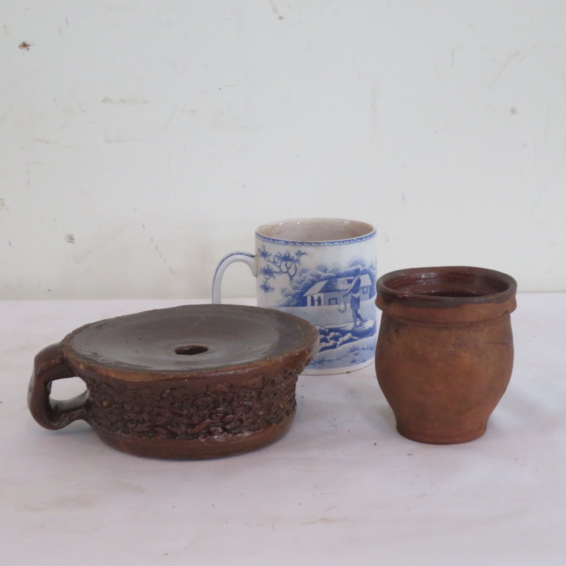 Lady's redware spittoon and mini redware jar: Lady's redware spittoon with finger hold, wriggle work around body and also a 3 1/4" t. redware ovoid jar attributed to Rockingham Co., Va.