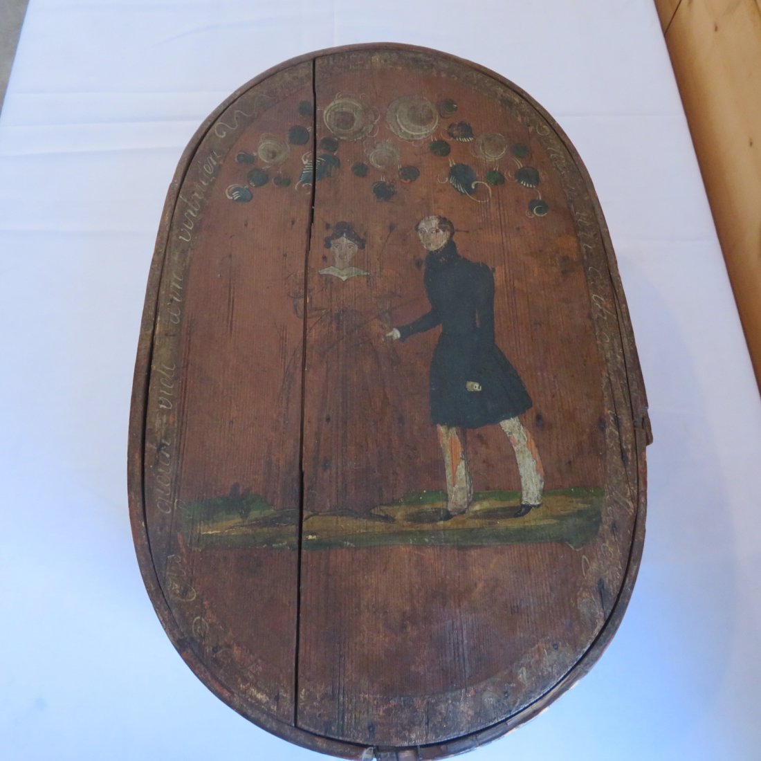 Early paint decorated bride: Early oval paint decorated bride box with bride & groom on lid, floral decoration on sides, 9" x 18.5" x 12"