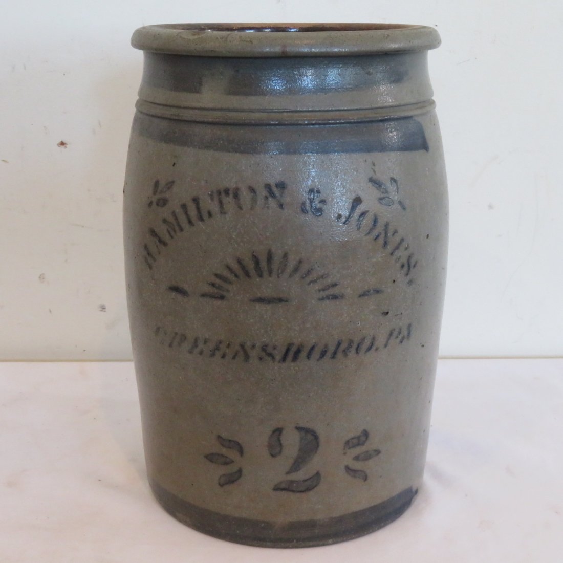 Hamilton & Jones 2 gal. stoneware jar: Hamilton & Jones 2 gal. stoneware jar with stenciled and free hand decoration, 12" x 7"