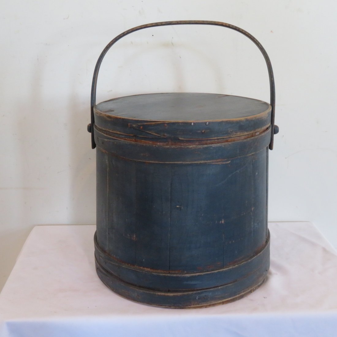 Large early wood firkin in old green paint: Large early wood firkin in old dark blue paint, copper tacks on wood fingers, top is 14 1/2" bottom is 15 1/2", 14.5" height