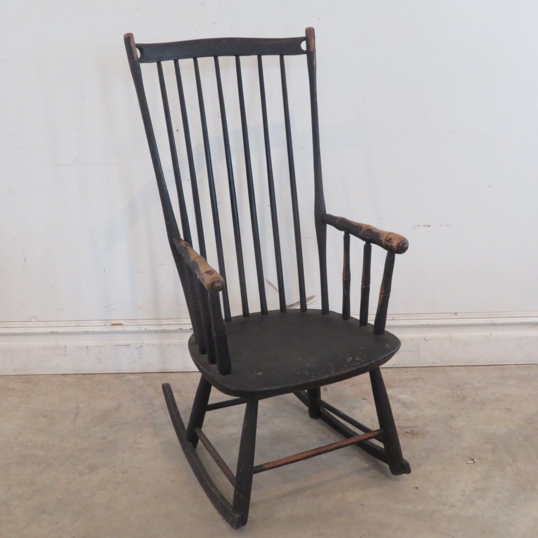 Early country Windsor rocker: Early country Windsor rocker in old worn black paint, 43" x 19" x 18.5"